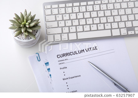 Curriculum vitae with pen and keyboard Curriculum vitae with pen and keyboard 63257907