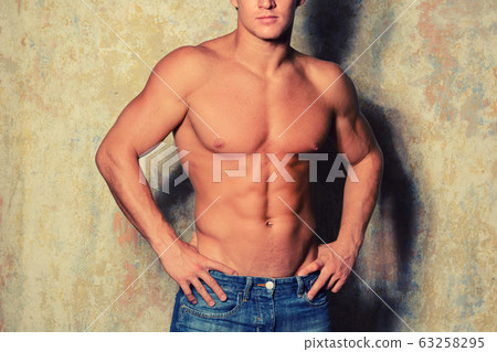 Portrait of a happy athletic man with muscular 63258295