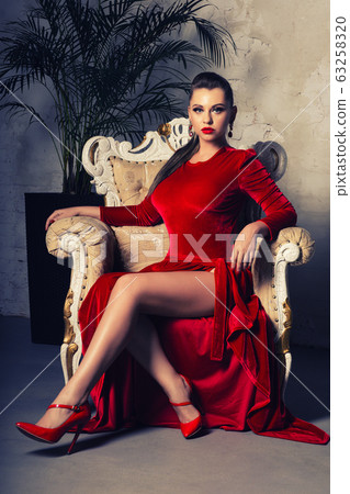 Magnificent young woman in luxurious red dress and Magnificent young woman in luxurious red dress and 63258320