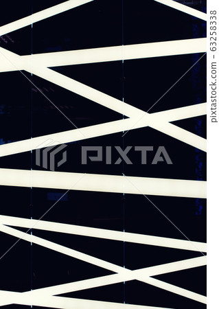 White intersecting stripes on a black background 63258338