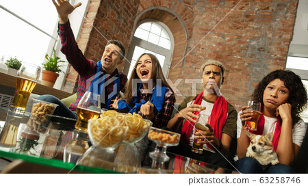 Excited group of people watching sport match, championship at home Excited group of people watching sport match, championship at home 63258746