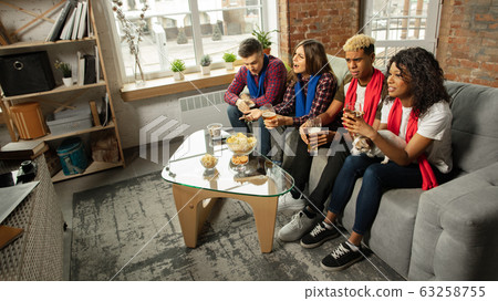 Excited group of people watching sport match, championship at home Excited group of people watching sport match, championship at home 63258755