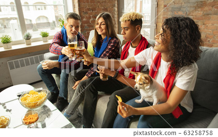 Excited group of people watching sport match, championship at home Excited group of people watching sport match, championship at home 63258758