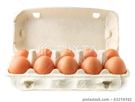 Open tray container of chicken eggs on a white 63259392