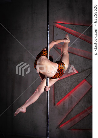 Beautiful girl training on the pole at studio Beautiful girl training on the pole at studio 63259620