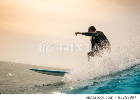 Surfer riding waves on the island of fuerteventura Surfer riding waves on the island of fuerteventura 63259994