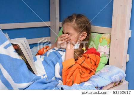 Sick girl sneezed heavily in bed Sick girl sneezed heavily in bed 63260617