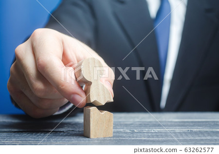 Man collects together a broken human figure. Psychological rehabilitation therapy. Depression, stress, health problems. Support, recovery from crisis. Medical healing , victory over cancer, diseases. 63262577