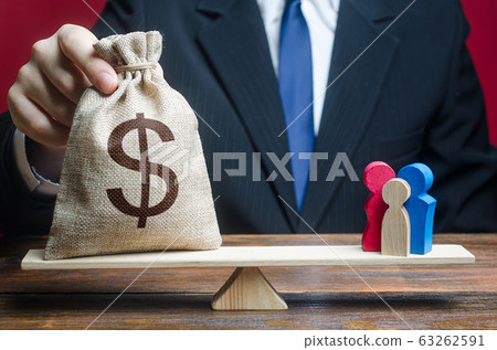 Man puts dollar money bag on scales with family figures. Social assistance, financial support for who in need, vulnerable populations. Charitable donations, invest in human capital. help aid migrants Man puts dollar money bag on scales with family figures. Social assistance, financial support for who in need, vulnerable populations. Charitable donations, invest in human capital. help aid migrants 63262591