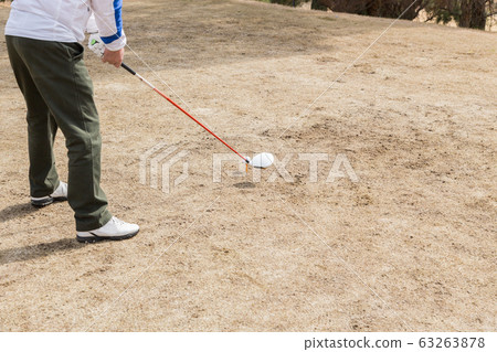 Men hitting a tee shot Men hitting a tee shot 63263878