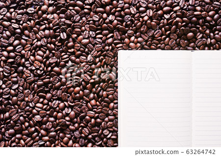 Opened notebook with lined coffee beans 63264742