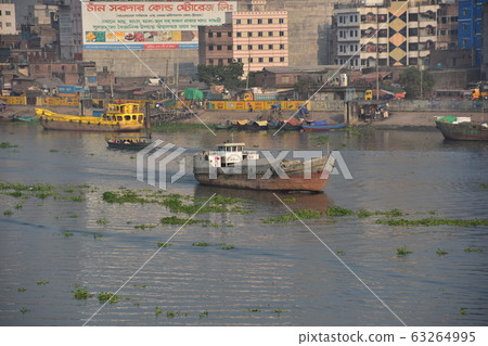 Dhaka, Bangladesh The old town along the Brigonga River Small ferry and medium-sized carrier passing through the river 63264995