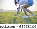 Woman golfer drop a golf ball in the rough area after lost of golf ball out of fairway 63268109