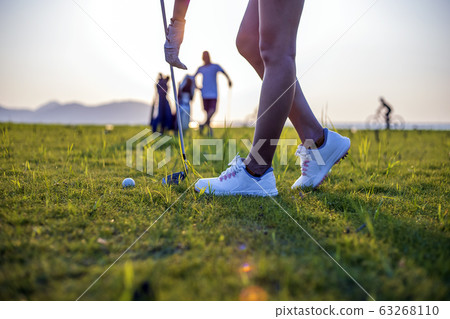 Woman golfer drop a golf ball in the rough area after lost of golf ball out of fairway 63268110
