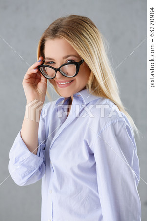 Portrait of a sexy woman in a man's shirt wearing glasses Portrait of a sexy woman in a man's shirt wearing glasses 63270984