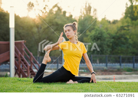 Girl doing yoga in the park at sunset Girl doing yoga in the park at sunset 63271091
