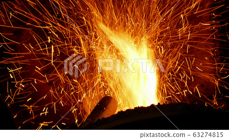 Fire burn pellets with spruce sawdust into delivery strew bio wooden pallets industrial modern boiler, sparks fly out flames fire detail closeup, biofuels made compressed matter organic biomass, fuel Fire burn pellets with spruce sawdust into delivery strew bio wooden pallets industrial modern boiler, sparks fly out flames fire detail closeup, biofuels made compressed matter organic biomass, fuel 63274815
