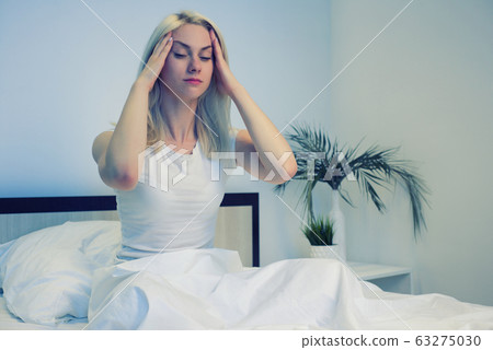 Depressed woman awake in the night, she is Depressed woman awake in the night, she is 63275030