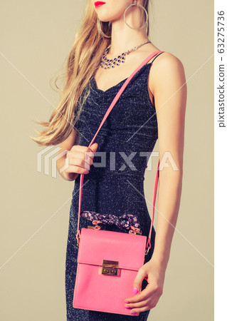 slim trendy woman in evening dress with pink bag 63275736