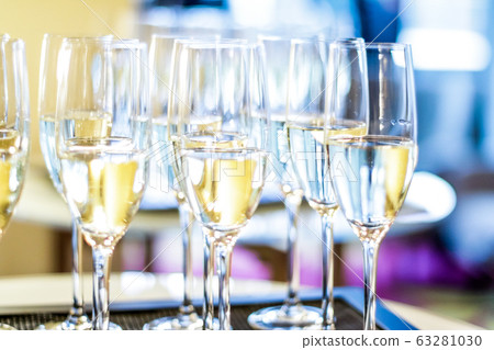 Glasses of champagne and sparkling wine served at charity event, alcoholic drinks Glasses of champagne and sparkling wine served at charity event, alcoholic drinks 63281030