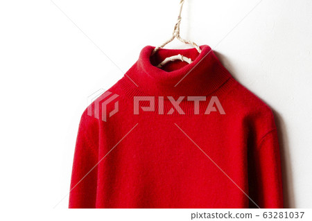 Close up of shoulder and collar of red turtle sweater on hanger with white background Close up of shoulder and collar of red turtle sweater on hanger with white background 63281037