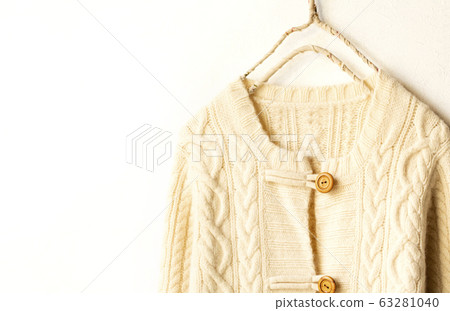 Light beige white thick cardigan on white background Light beige white thick cardigan on white background 63281040