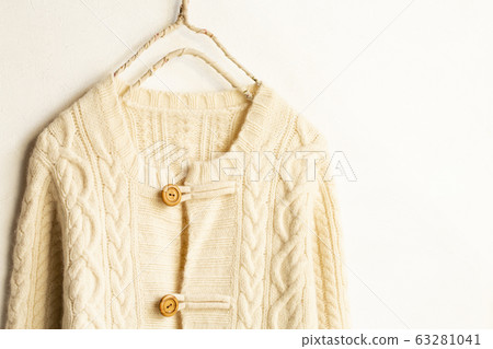 Light beige white thick cardigan on white background Light beige white thick cardigan on white background 63281041