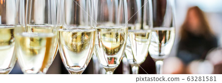 Glasses of champagne and sparkling wine served at charity event, alcoholic drinks Glasses of champagne and sparkling wine served at charity event, alcoholic drinks 63281581