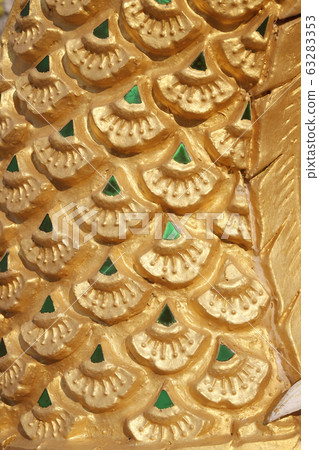 Dragon scales statue. Stucco surface background. 63283353
