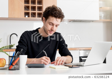 Man making financial revision 63286124