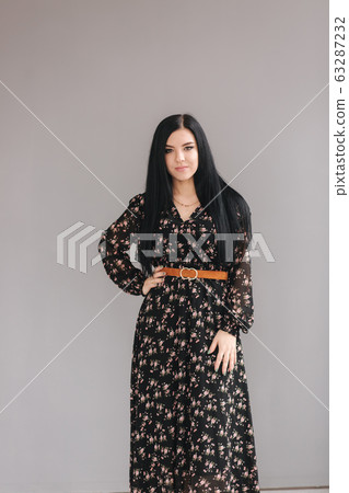 Young brunette model demonstating spring clothes in studio Young brunette model demonstating spring clothes in studio 63287232