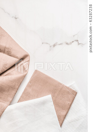 Folded napkin and kitchen towel set on white marble background, table decor 63287238