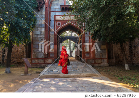 Indian woman in red sari near Arab Ki Sarai 63287910