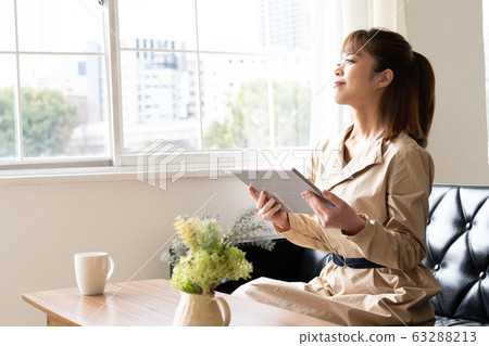 Woman using a lifestyle tablet 63288213