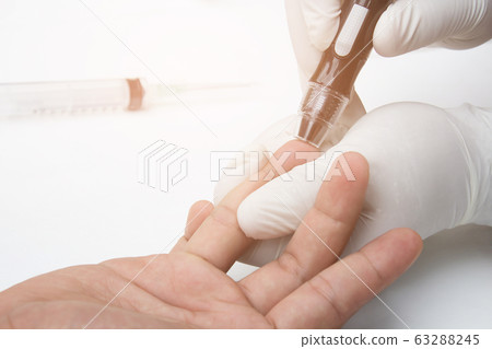 Doctor hand bleeding patient blood for blood checking in lab hospital  63288245