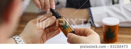 Flask with hush on wooden table 63288473