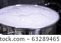 Water boiling in a pot. Cooking udon. 63289465