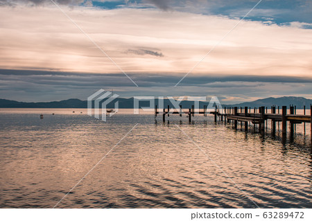 Sunset view of a sailboat and dock in Lake Tahoe, Homewood Sunset view of a sailboat and dock in Lake Tahoe, Homewood 63289472