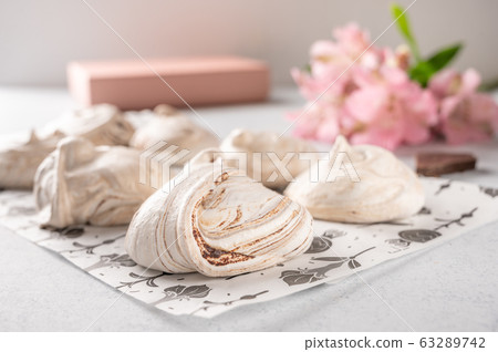 Homemade eggs dessert meringue on a light background. Next to pink flower and gift box. Copy space Homemade eggs dessert meringue on a light background. Next to pink flower and gift box. Copy space 63289742
