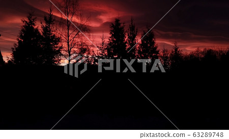 Beautiful dramatic red sunset in winter mountains Beautiful dramatic red sunset in winter mountains 63289748