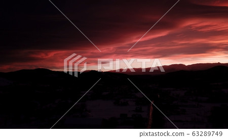 Beautiful dramatic red sunset in winter mountains Beautiful dramatic red sunset in winter mountains 63289749