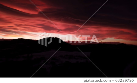 Beautiful dramatic red sunset in winter mountains Beautiful dramatic red sunset in winter mountains 63289750