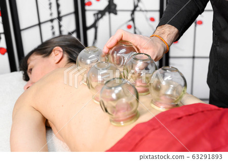 Traditional Chinese Medicine therapy. Cupping therapy, a treatment used for pain relief and other Traditional Chinese Medicine therapy. Cupping therapy, a treatment used for pain relief and other 63291893