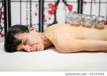 Traditional Chinese Medicine therapy. Cupping therapy, a treatment used for pain relief and other Traditional Chinese Medicine therapy. Cupping therapy, a treatment used for pain relief and other 63291896