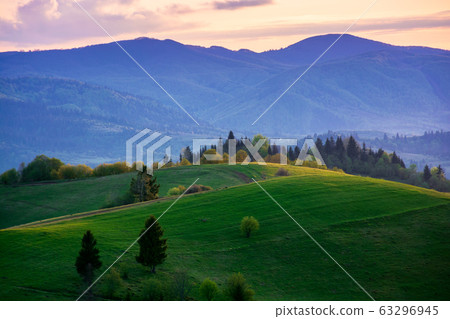 mountainous countryside in springtime at dusk 63296945