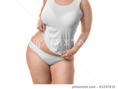 Fat woman showing her waist - isolated over white background. Fat woman showing her waist - isolated over white background. 63297610