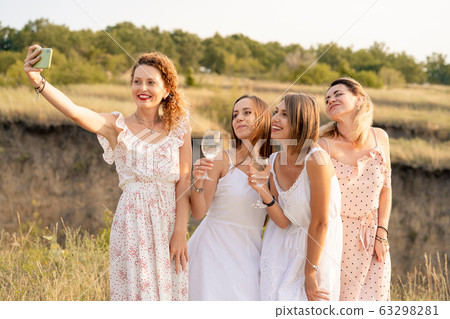 The company of stylish happy female friends having The company of stylish happy female friends having 63298281