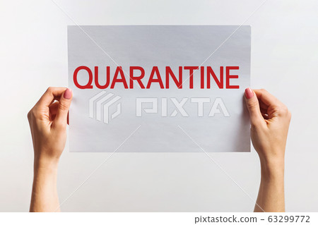Woman's hands holding paper with text Quaranntine 63299772