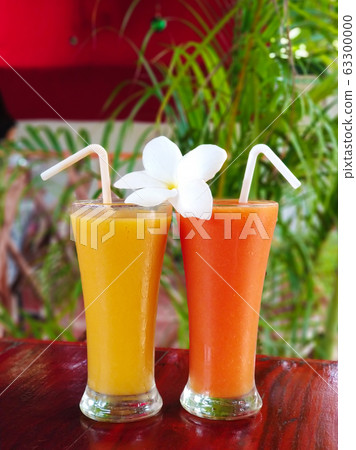 Two glass glasses with freshly squeezed juice and Two glass glasses with freshly squeezed juice and 63300000