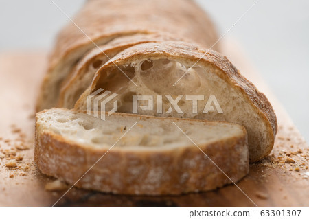 sliced freshly baked ciabatta bread on olive board sliced freshly baked ciabatta bread on olive board 63301307